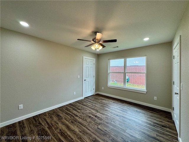 unfurnished bedroom with ceiling fan and dark hardwood / wood-style flooring