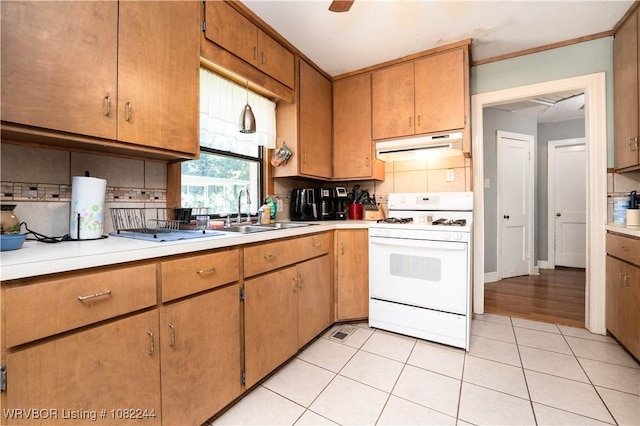 4300 Tilles Ave, Fort Smith, AR 72903 - kitchen featuring white gas stove, under cabinet range hood, backsplash, light countertops, and ornamental molding