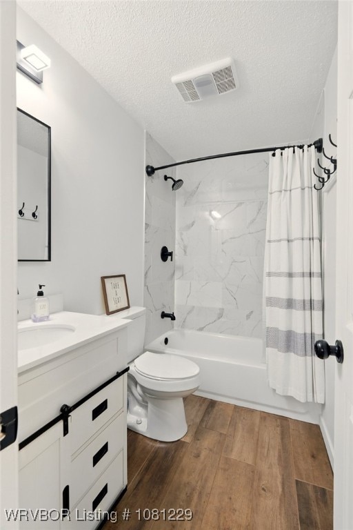 9010 Skypark Dr, Fort Smith, AR 72903 - full bathroom featuring vanity, a textured ceiling, wood finished floors, shower / bath combo with shower curtain, and toilet