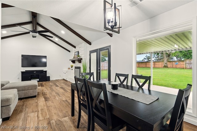 9010 Skypark Dr, Fort Smith, AR 72903 - dining area with hardwood / wood-style flooring, recessed lighting, a chandelier, ceiling fan, and a stone fireplace