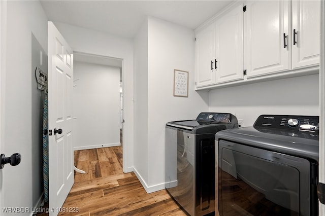 9010 Skypark Dr, Fort Smith, AR 72903 - laundry room featuring washing machine and dryer, cabinet space, wood finished floors, and baseboards