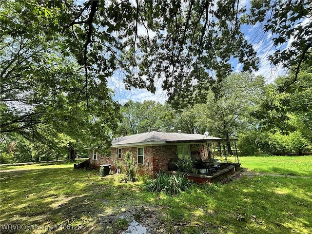 112463 S 4670th Rd, Gans, OK 74936 - view of property exterior featuring a yard and brick siding