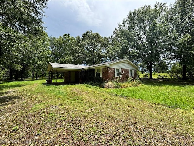 112463 S 4670th Rd, Gans, OK 74936 - view of front facade with a front lawn, a carport, and brick siding