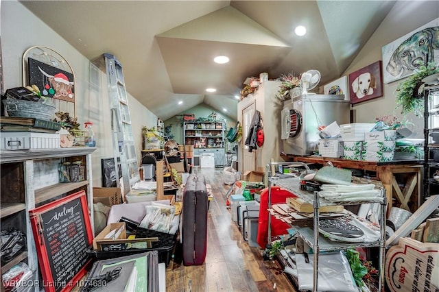 miscellaneous room with hardwood / wood-style flooring and vaulted ceiling