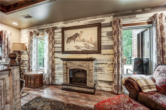 sitting room featuring a fireplace and hardwood / wood-style flooring