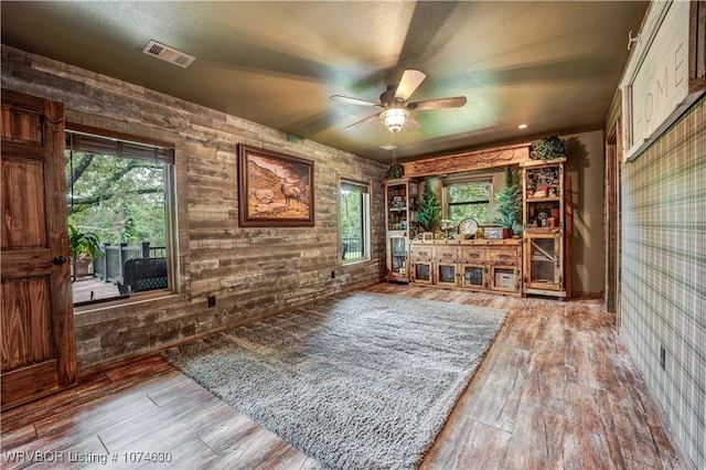 interior space with ceiling fan and wood-type flooring