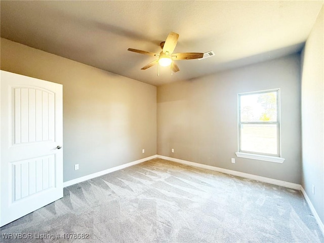 carpeted empty room featuring ceiling fan