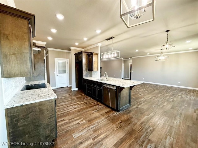 kitchen with sink, decorative light fixtures, stainless steel dishwasher, and light stone countertops