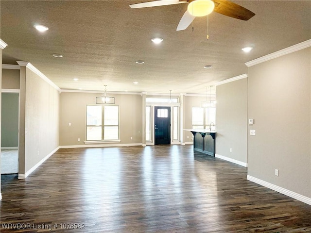 unfurnished living room with crown molding, ceiling fan, and dark hardwood / wood-style floors