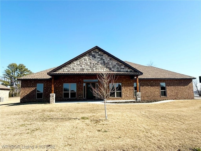 rear view of house featuring a yard