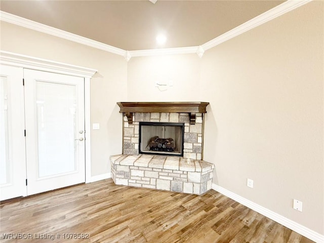 unfurnished living room featuring ornamental molding, hardwood / wood-style floors, and a fireplace