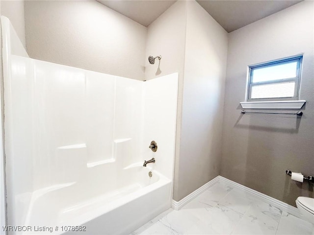 bathroom with toilet and bathtub / shower combination