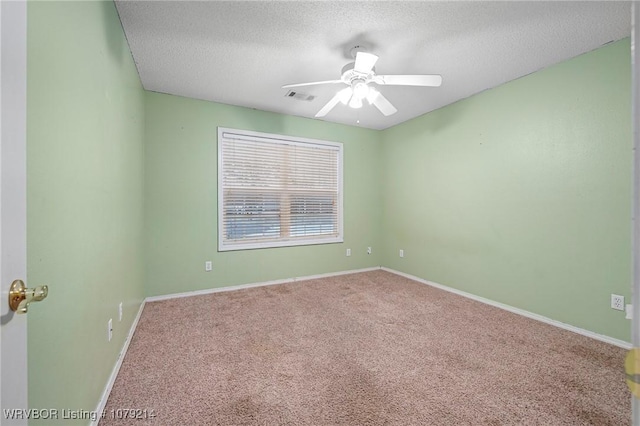 carpeted empty room featuring visible vents, ceiling fan, a textured ceiling, and baseboards