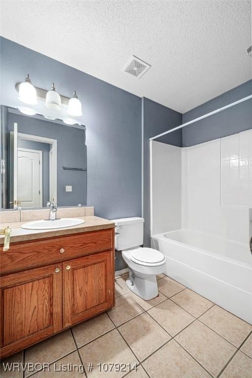 bathroom featuring visible vents, toilet, a textured ceiling, vanity, and tile patterned flooring