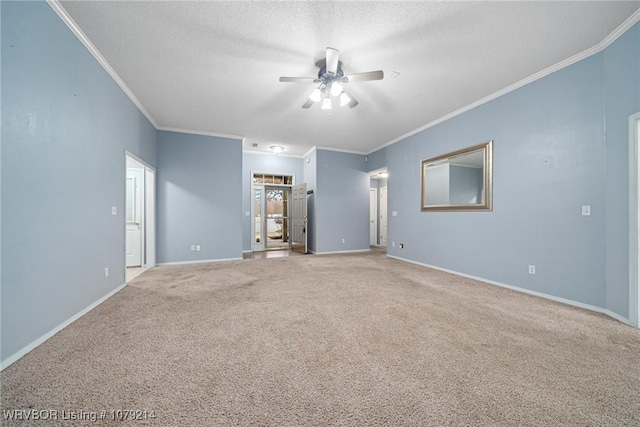 unfurnished room with crown molding, a textured ceiling, and baseboards