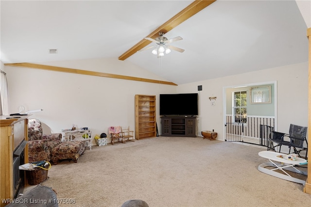 carpeted living room featuring lofted ceiling with beams and ceiling fan