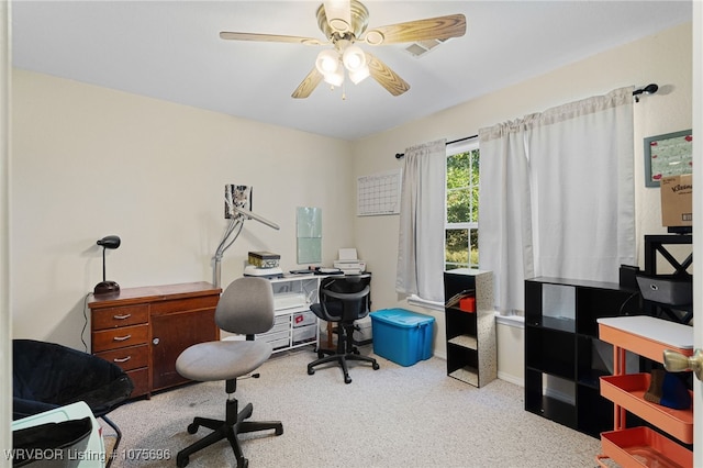 office area featuring light carpet and ceiling fan