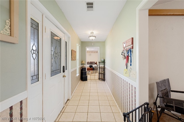 corridor with light tile patterned flooring