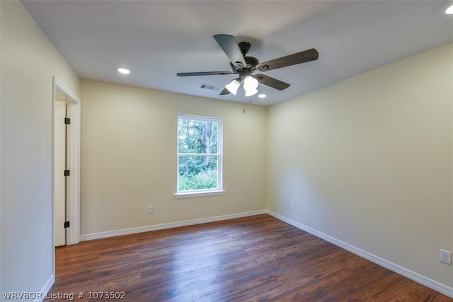 spare room with dark hardwood / wood-style floors and ceiling fan