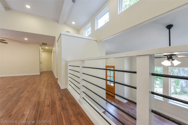 hallway featuring beam ceiling, dark wood-type flooring, and high vaulted ceiling