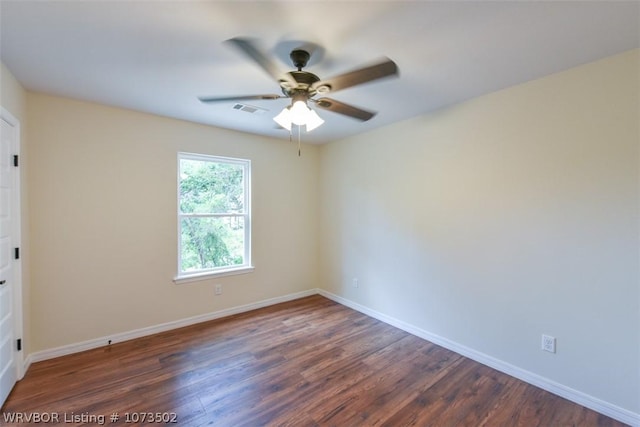 empty room with ceiling fan and dark hardwood / wood-style flooring