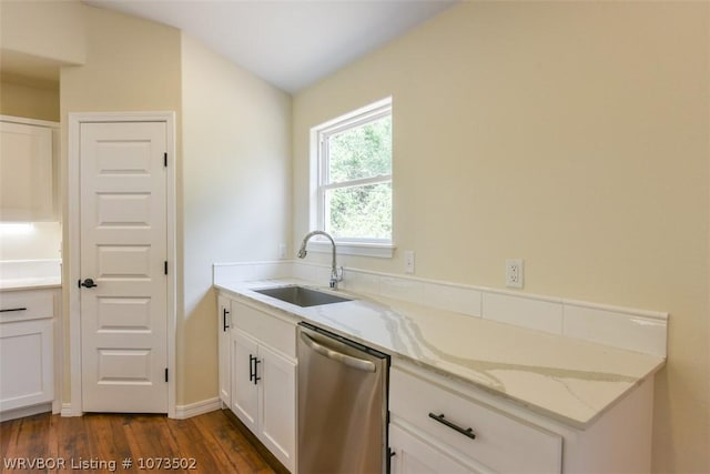 kitchen with light stone countertops, sink, dark wood-type flooring, stainless steel dishwasher, and white cabinets