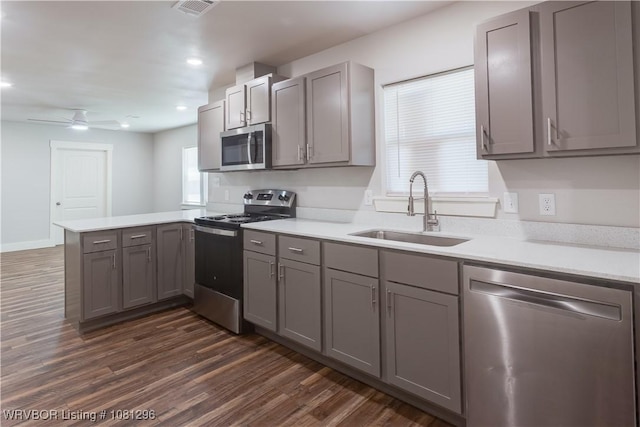 3305 Spradling Ave, Fort Smith, AR 72904 - kitchen featuring stainless steel appliances, a sink, gray cabinetry, a peninsula, and a ceiling fan