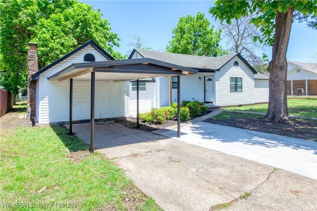 3305 Spradling Ave, Fort Smith, AR 72904 - ranch-style house featuring concrete driveway, a carport, a front yard, and a chimney