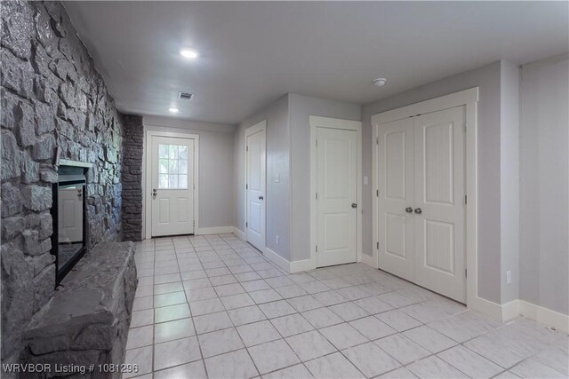 3305 Spradling Ave, Fort Smith, AR 72904 - foyer featuring light tile patterned floors, a stone fireplace, baseboards, and recessed lighting