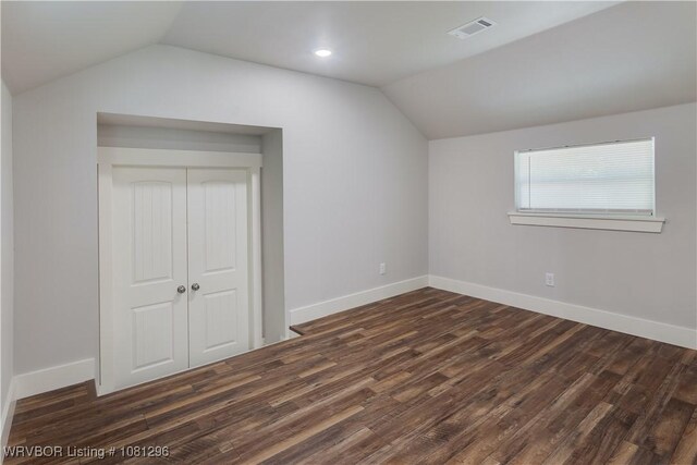 3305 Spradling Ave, Fort Smith, AR 72904 - unfurnished bedroom featuring vaulted ceiling, dark wood-style flooring, a closet, and baseboards
