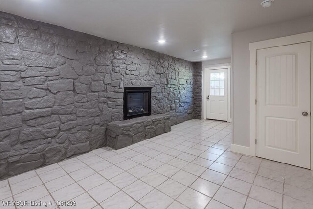 3305 Spradling Ave, Fort Smith, AR 72904 - unfurnished living room with light tile patterned flooring and a fireplace