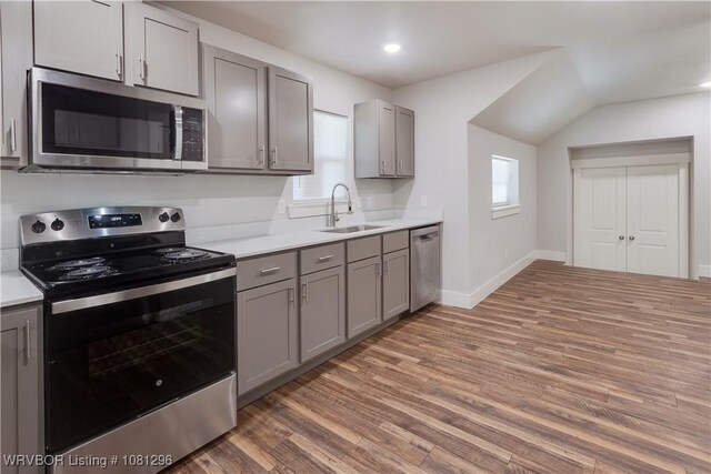 3305 Spradling Ave, Fort Smith, AR 72904 - kitchen featuring appliances with stainless steel finishes, a sink, gray cabinets, light countertops, and light wood-style floors