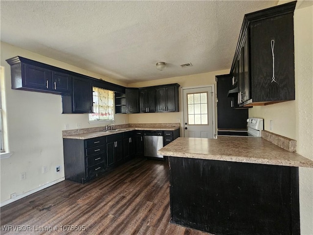 kitchen featuring dishwasher, dark hardwood / wood-style flooring, a wealth of natural light, and electric stove