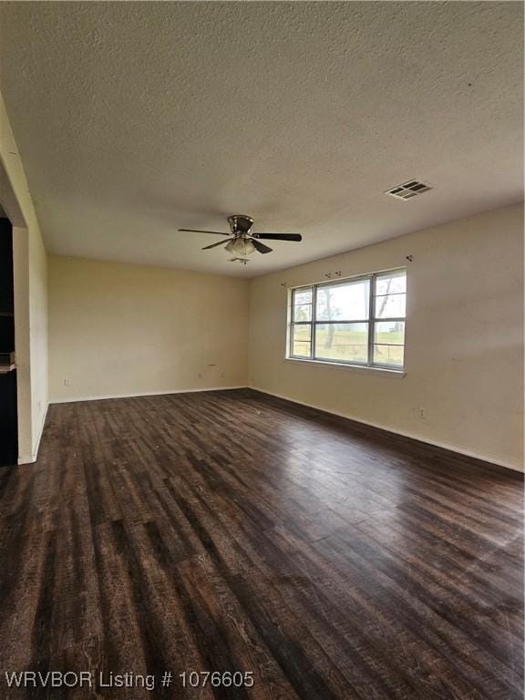 unfurnished room with ceiling fan and a textured ceiling