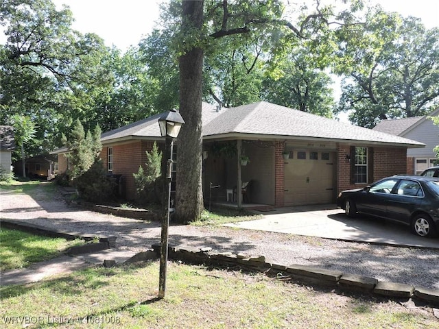 2016-2018 S V St, Fort Smith, AR 72901 - view of front of house with brick siding, an attached garage, and gravel driveway