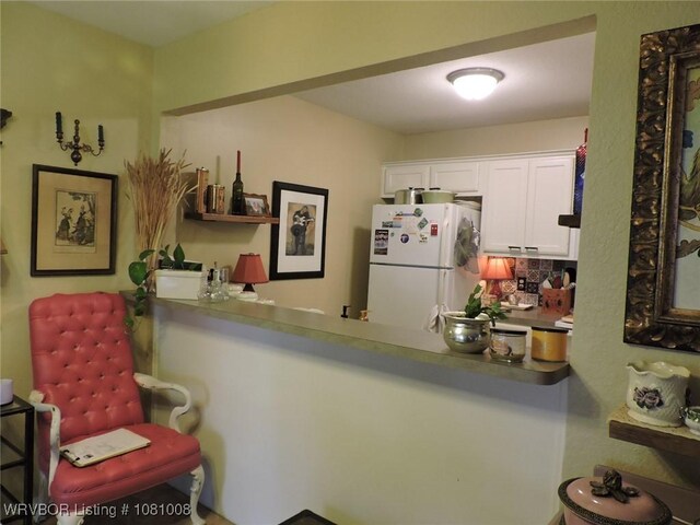 2016-2018 S V St, Fort Smith, AR 72901 - kitchen featuring freestanding refrigerator, decorative backsplash, and white cabinets