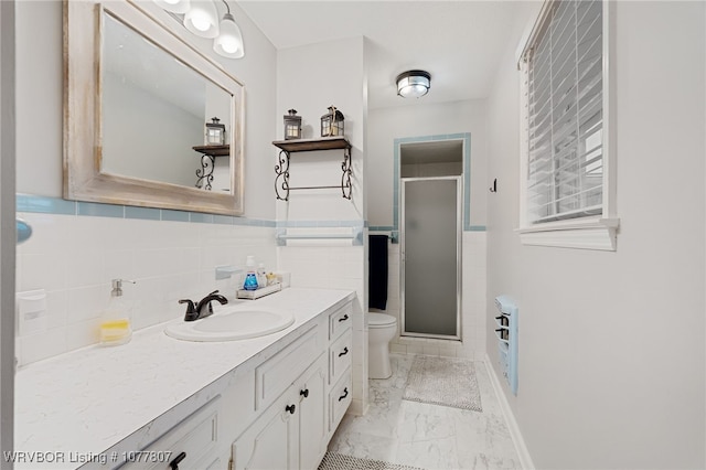 bathroom with walk in shower, vanity, heating unit, tile walls, and toilet