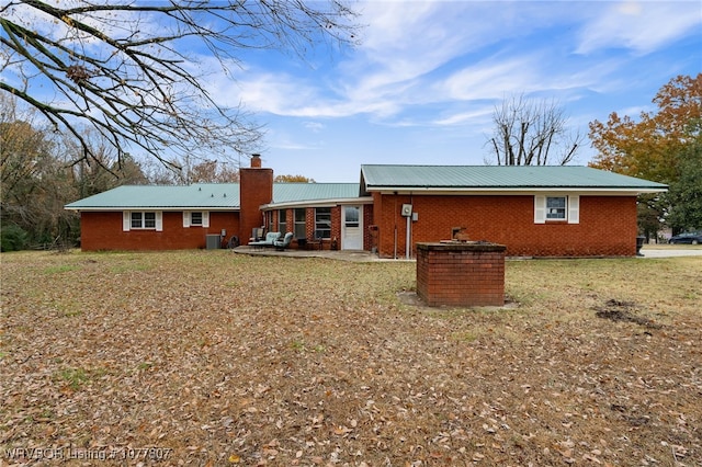 back of property featuring a yard and central AC unit