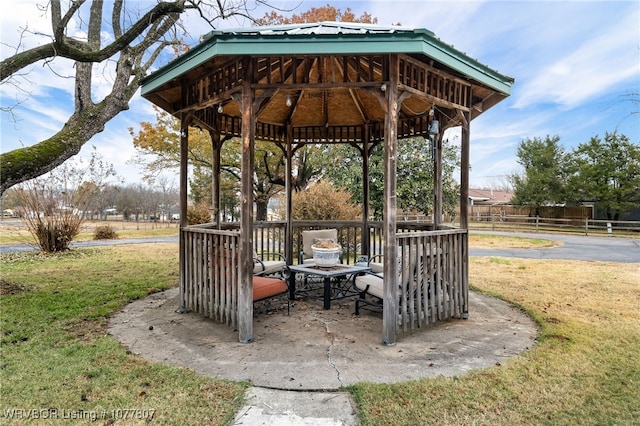 surrounding community with a lawn and a gazebo