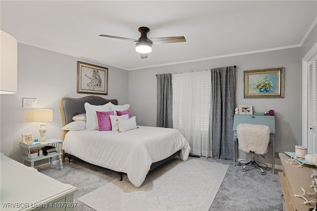 bedroom featuring carpet, ceiling fan, ornamental molding, and a closet