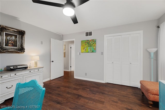 interior space with ceiling fan and dark wood-type flooring