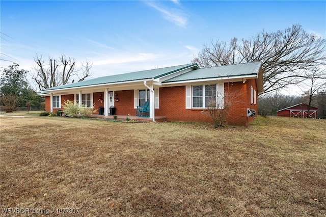 single story home with covered porch and a front yard