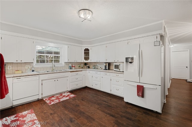 kitchen featuring dark hardwood / wood-style flooring, tasteful backsplash, white appliances, sink, and white cabinets