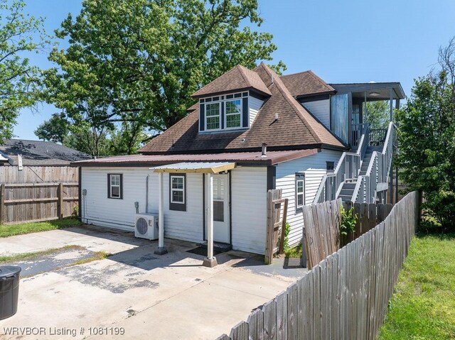 2101 Birnie Ave, Fort Smith, AR 72904 - rear view of property featuring a cooling unit, a patio, a fenced backyard, a shingled roof, and stairway