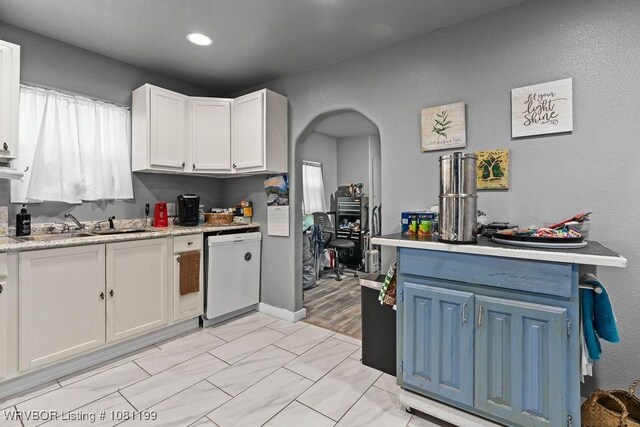 2101 Birnie Ave, Fort Smith, AR 72904 - kitchen featuring dishwasher, a sink, light countertops, white cabinets, and blue cabinetry
