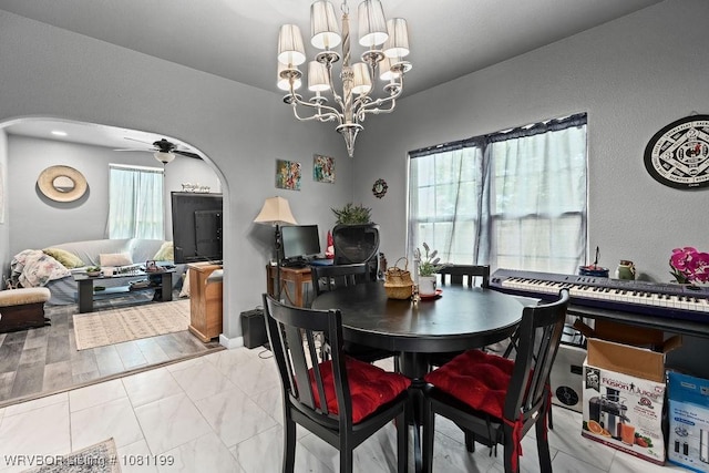 2101 Birnie Ave, Fort Smith, AR 72904 - dining room with arched walkways, a ceiling fan, a chandelier, and marble finish flooring