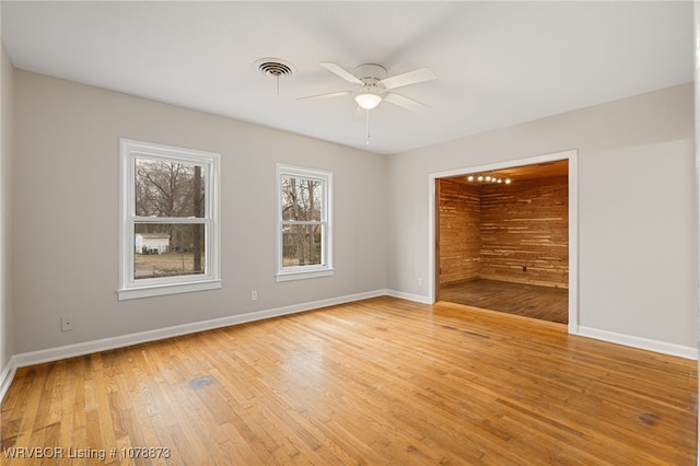 spare room with ceiling fan and light wood-type flooring