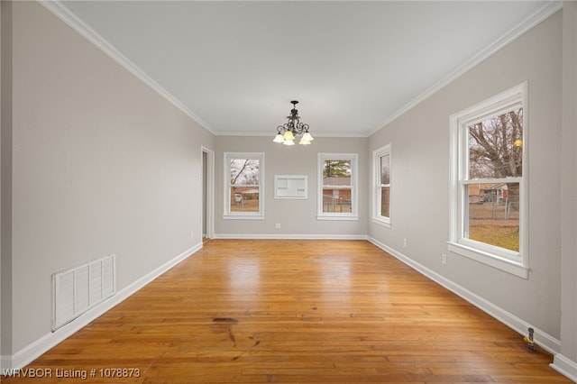 unfurnished dining area with crown molding, a notable chandelier, and light hardwood / wood-style flooring