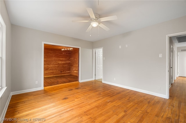 empty room with ceiling fan and light wood-type flooring