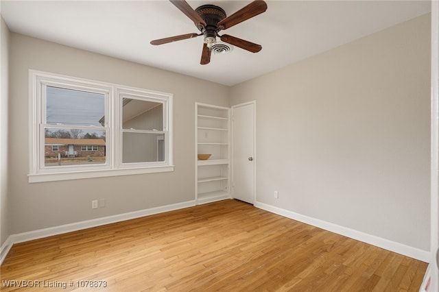 unfurnished room with wood-type flooring and ceiling fan